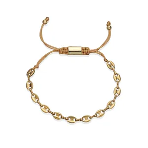 Close-up of gold stainless steel coffee bean link bracelet with adjustable cord closure