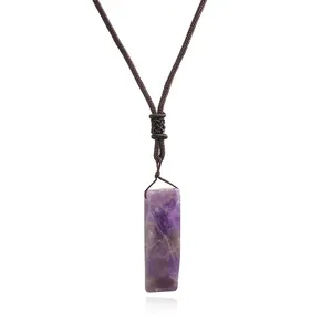 Close-up of rectangular natural amethyst stone pendant with woven brown cord