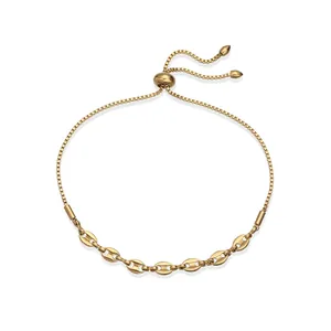 Detail of a gold stainless steel mariner link bracelet with adjustable bolo closure