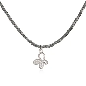 Detail of elegant butterfly pendant necklace with cubic zirconia and metallic cube beads