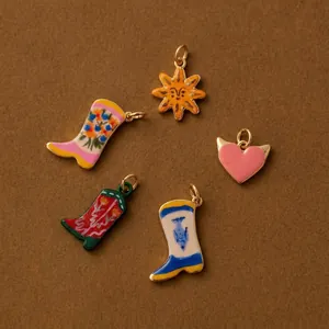 Detailed macro view of colorful enamel shoe charms in sun, heart, and boot shapes.