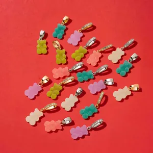Close-up of assorted colorful resin bear pendants featuring pave crystal bails on red