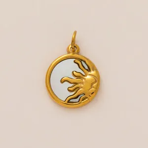 Detailed view of a circular gold sun motif pendant charm featuring a light blue inlay