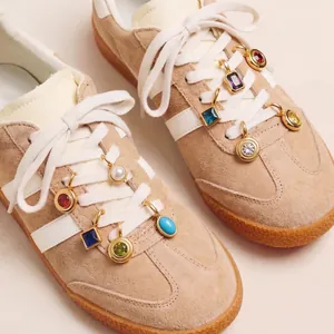 Close-up detail of colorful 12 birthstone shoe charms with 18K gold plating on sneakers