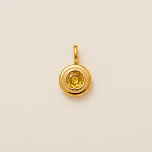 Macro view of a round 18K gold plated stainless steel shoe charm with yellow zircon