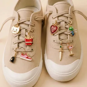 Detailed view of various colorful enamel DIY shoe charms attached to sneaker laces