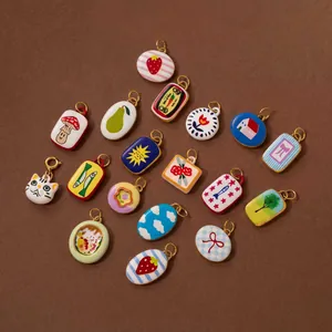 Close-up of diverse colorful DIY charms featuring fruit, animal, and nature designs