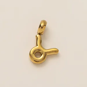 Detailed macro shot of 18K gold plated Taurus zodiac charm in smooth polished finish.
