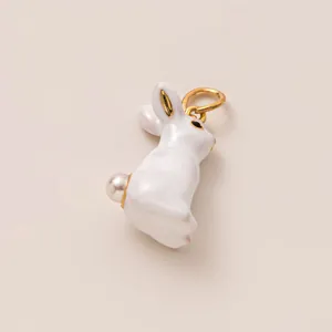 Detail of white enamel rabbit charm with pearl tail and gold-tone loop