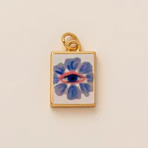 Exquisite copper rectangular charm featuring a blue flower with central evil eye motif