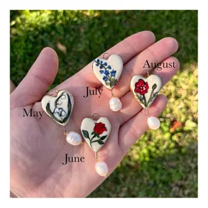 Handmade heart pendants with December birth flowers and baroque pearls, set of four