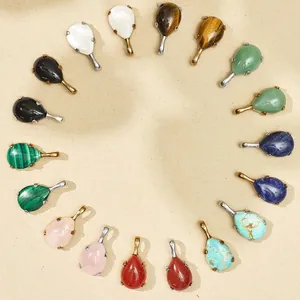 Macro view of colorful teardrop gemstone pendants with gold and silver steel settings