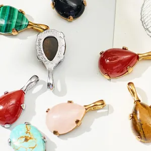 Close-up view of teardrop gemstone pendants in various colors like rose quartz and malachite