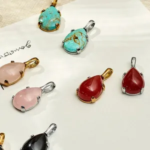 Detailed view of various colorful teardrop gemstone pendants in gold and silver settings.