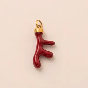Detailed view of a red coral-shaped pendant with a gold bail for DIY jewelry creations.