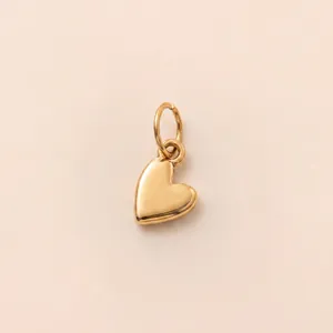 Close-up of 18K gold-plated heart pendant with polished finish and secure jump ring.
