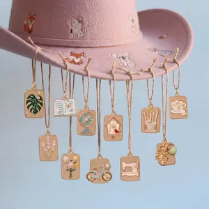 Detailed view of assorted gold enamel pendants with nature and lifestyle motifs.