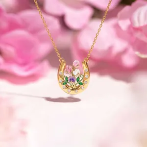 Detail of horseshoe necklace with enamel carnations and violet flowers