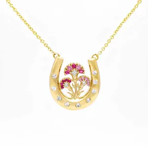 Exquisite gold horseshoe pendant necklace with intricately set pink floral details