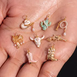 Detailed view of western cowboy charms including hat, cactus, and bull skull with pearls