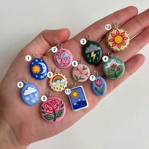 Hand-painted weather and floral pendants featuring sun, moon, and rose designs