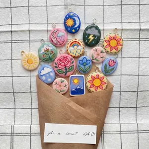 Collection of hand-painted weather and flower ceramic pendants in a bouquet arrangement