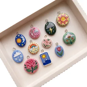 Hand-painted style celestial and floral pendants featuring sun, moon, and rose designs