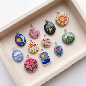 Detailed view of colorful weather and flower themed ceramic pendants for DIY jewelry making