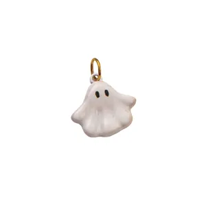 Gros plan d'un pendentif fantôme en émail blanc avec un anneau de suspension doré poli