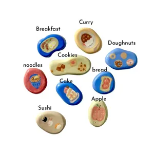 Food themed pebble charms for DIY jewelry featuring painted sushi breakfast and dessert icons.