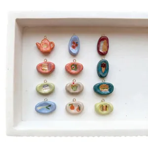 Set of 12 handmade food theme ceramic pendants featuring teapot and burger motifs.