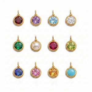 Macro detail of twelve vintage gold-plated birthstone pendants in a structured grid layout