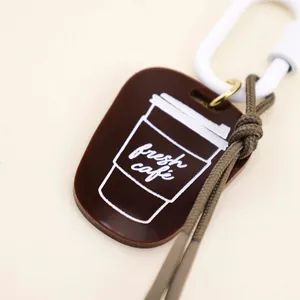 Minimalist brown acrylic coffee cup keychain charm with 'fresh cafe' print for bags.