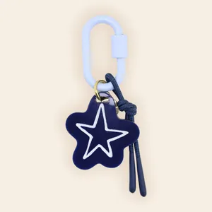 Close-up of a nautical blue star pendant with hand-painted outline and rope detail