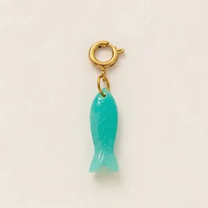 Detailed shot of a vibrant turquoise fish charm with a gold-toned spring clasp.