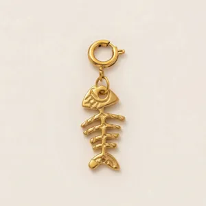 Detailed macro view of a golden fishbone charm pendant with spring ring clasp for jewelry