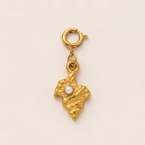 Detailed macro shot of an 18K gold-plated irregular pendant with a white pearl inlay