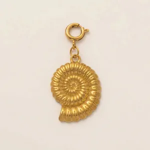 Detailed macro view of 18K gold-plated stainless steel ammonite shell pendant charm.