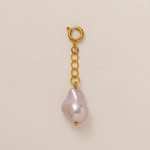 Close-up of 18K gold plated stainless steel pendant with pink baroque pearl.