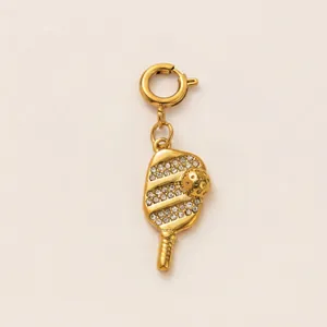 Detailed shot of 18K gold plated stainless steel pickleball paddle charm with crystals