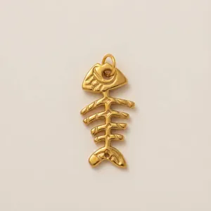 Detailed view of a gold-plated fishbone pendant with intricate skeletal textures.