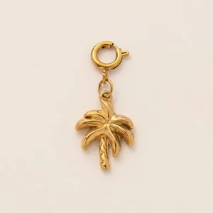 Detailed view of a gold-plated stainless steel palm tree pendant with a secure clasp