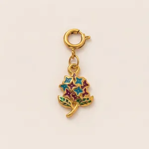 Detailed view of 18K gold-plated stainless steel floral charm with enamel and spring ring clasp