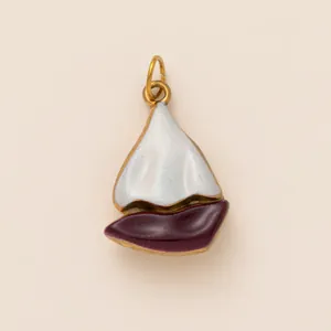 Detail view of a vintage enamel sailboat charm for DIY bag accessories and jewelry