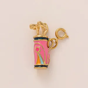 Detail of golf bag charm with pink enamel and gold-toned finish for jewelry making