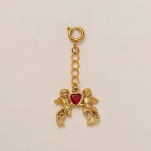 Detail view of 18K gold-plated stainless steel pendant featuring two cherubs with a red heart.
