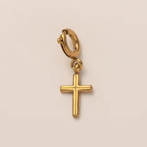 Detailed macro shot of a gold-plated stainless steel cross pendant accessory