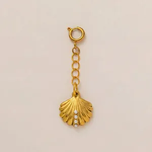 Detailed macro view of 18K gold plated stainless steel shell charm with white pearls