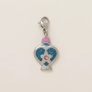 Detail view of heart-shaped stainless steel pendant with blue glitter and pink gem.