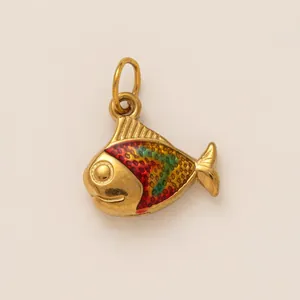 Macro view of a colorful fish pendant accessory made of gold-plated stainless steel.